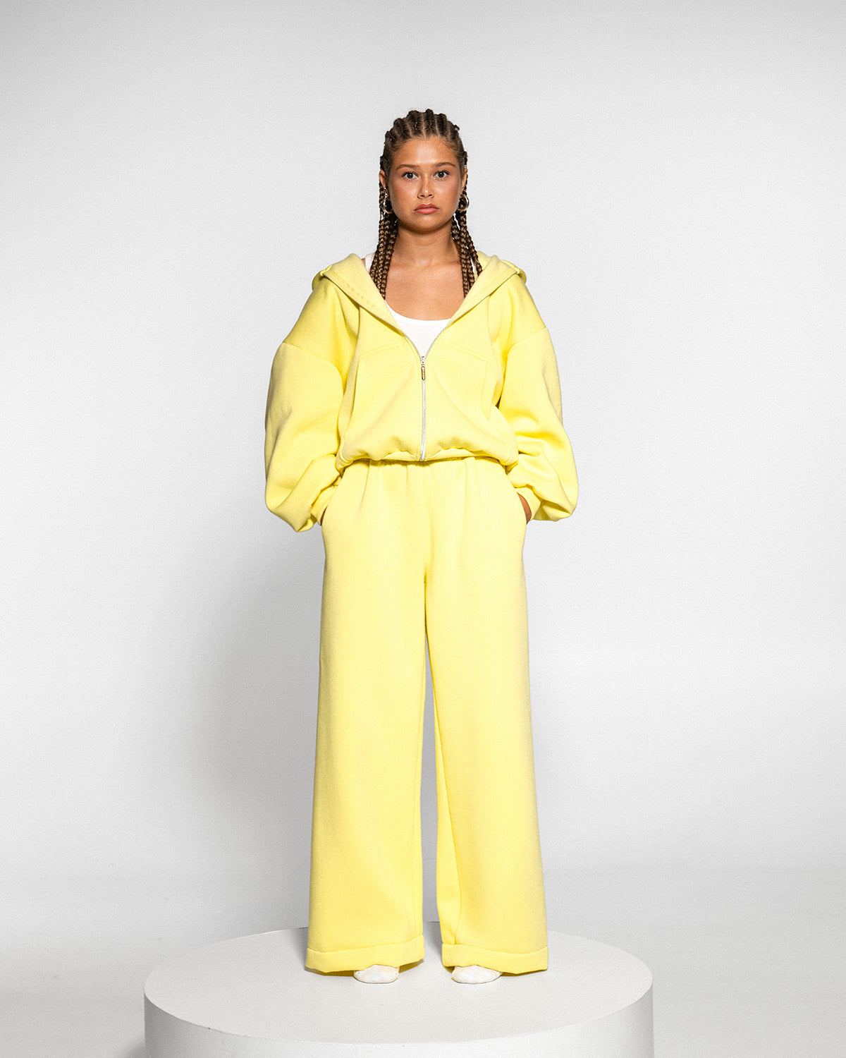 Model wearing a yellow tracksuit with a zip, full length